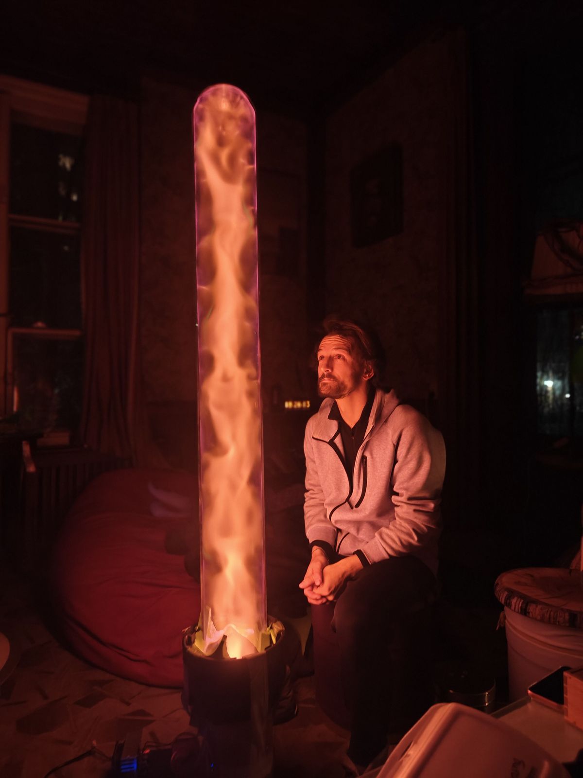 Man watching an orange plasma tube