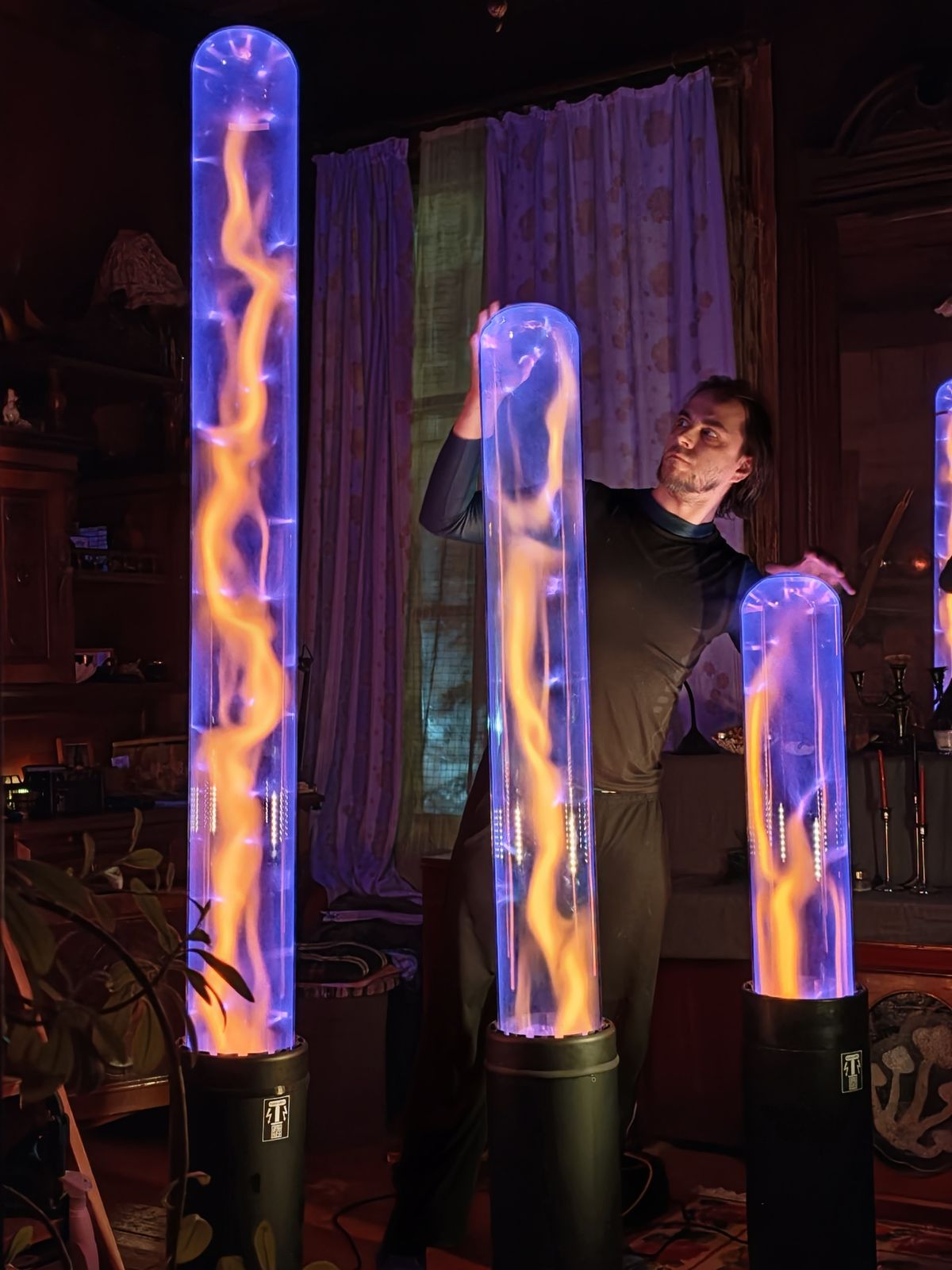 Three violet plasma tubes with their maker