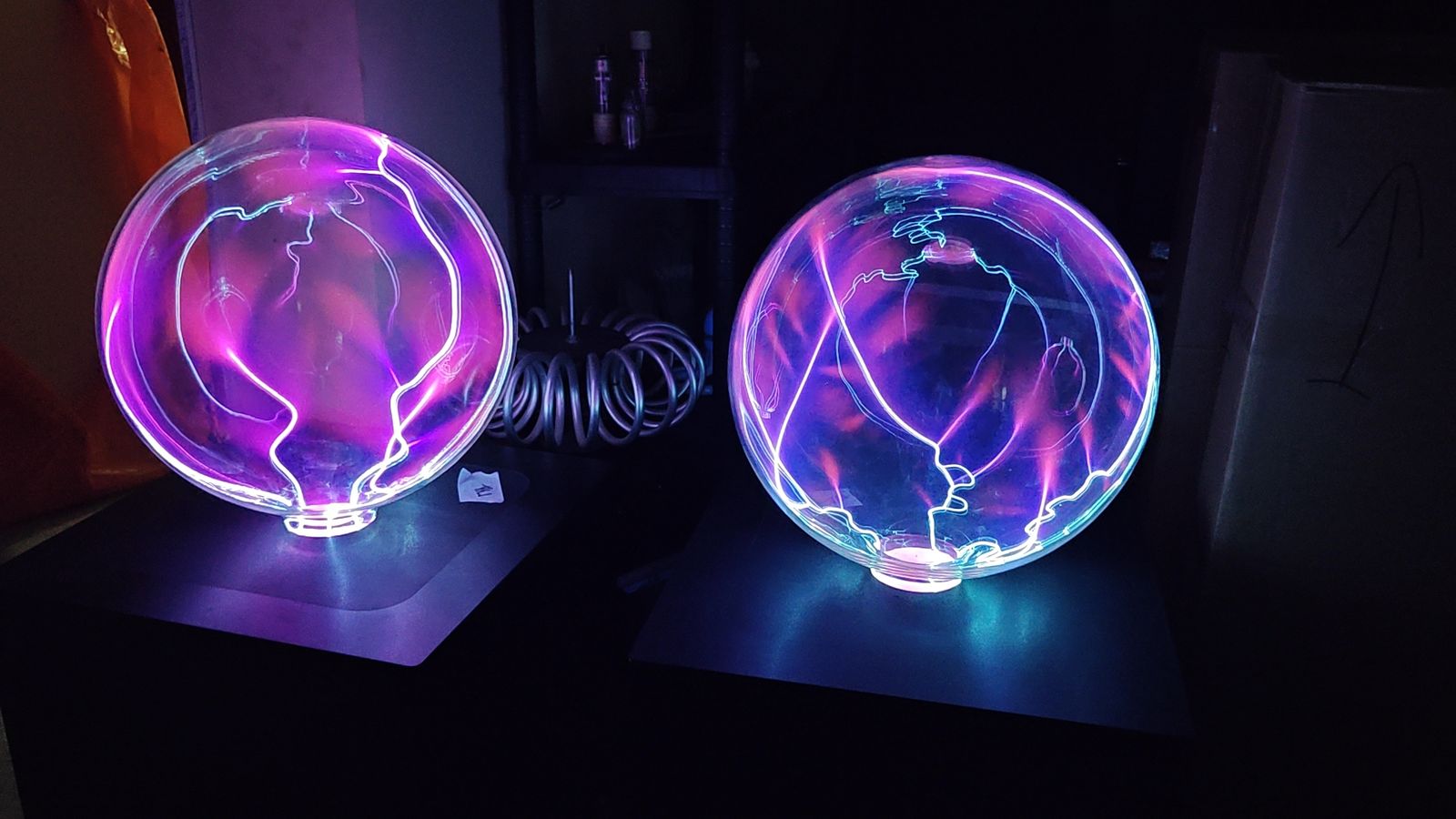 Two plasma spheres, pink and cyan